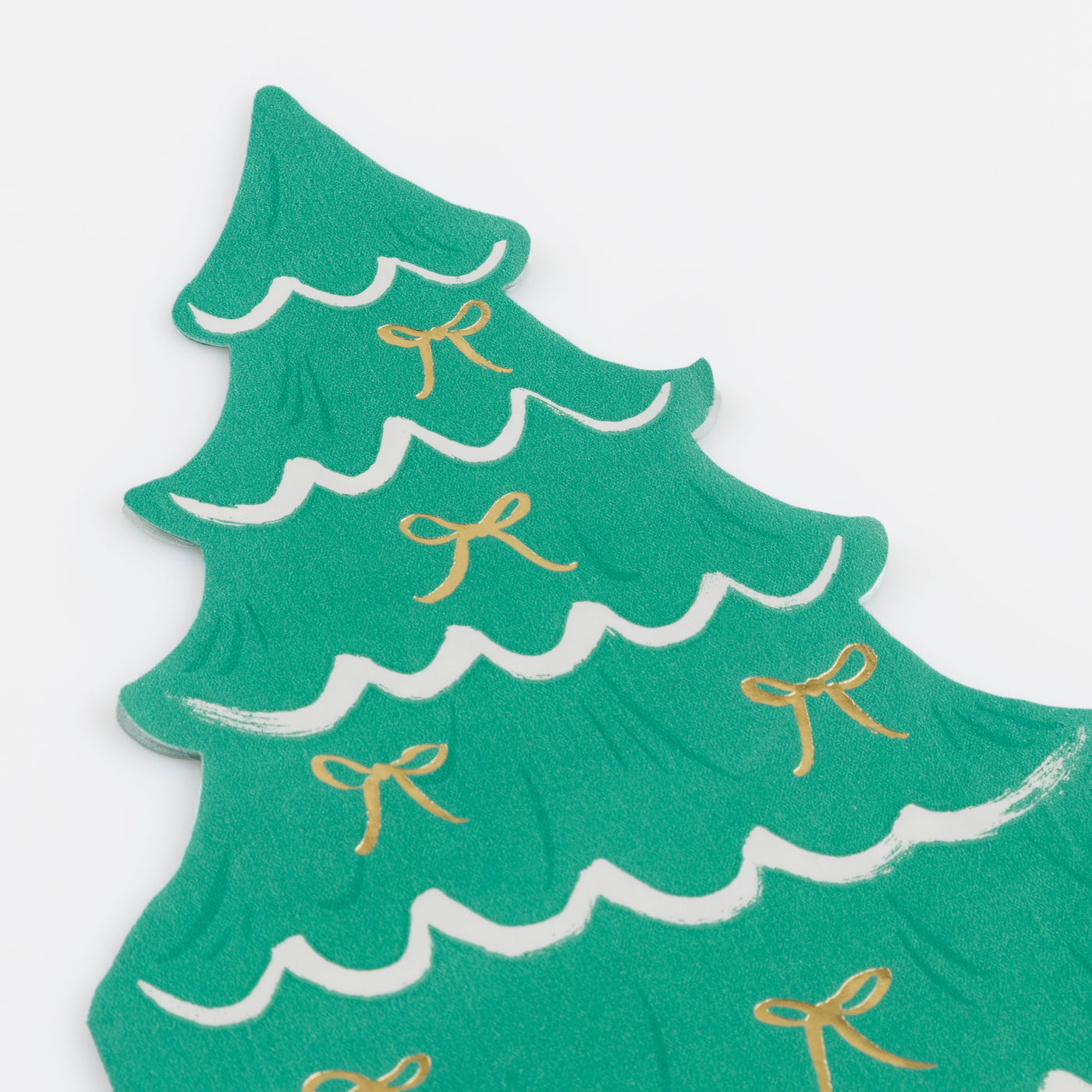 Green Christmas tree-shaped napkin with gold bows on a white background.