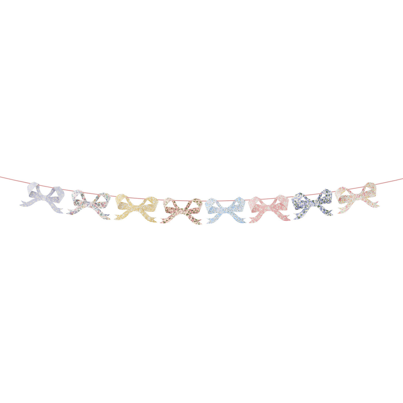 Eight bow pennants in floral Liberty print designs strung on ribbon.