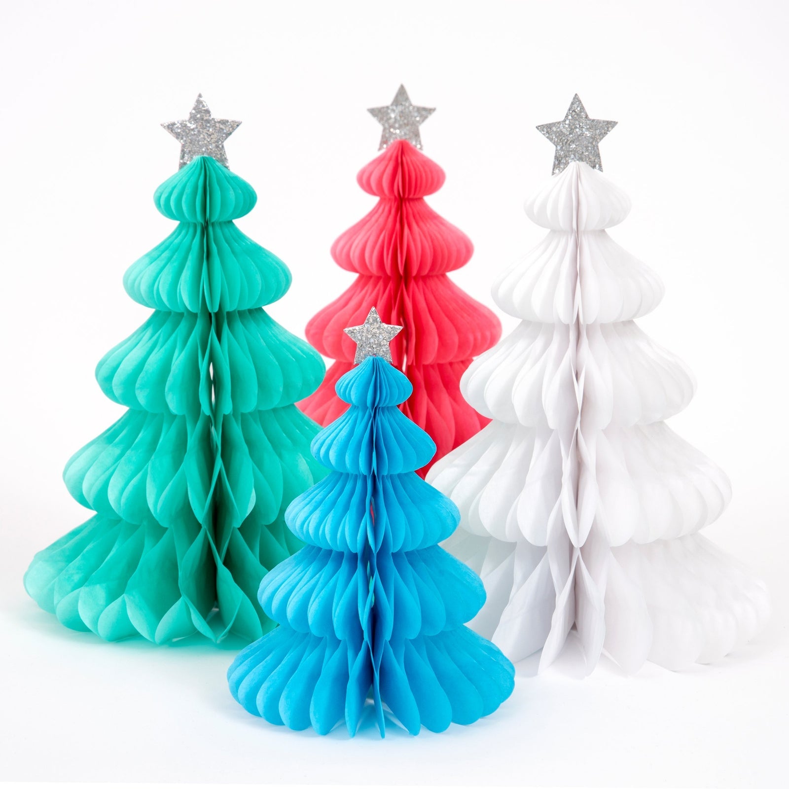 Four colorful paper Christmas trees with star toppers on a white background