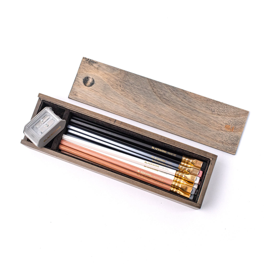 A set of Blackwing Rustic Boxed Set- Mixed pencils with a Two-Step Long Point Sharpener inside a Blackwing Rustic Box Set.