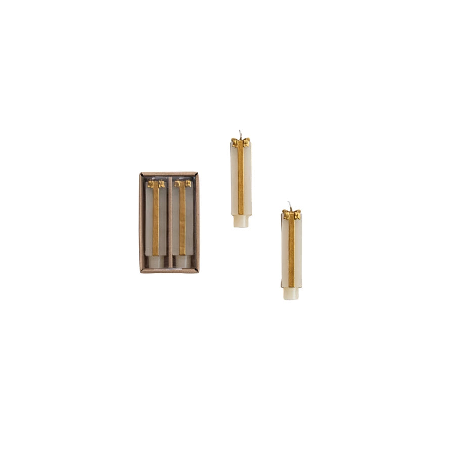 Two Short Unscented Cream & Gold Present Shaped Taper Candles packaged in a brown box and two on a white background.