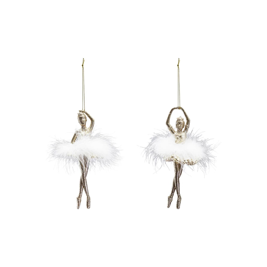 Two ballerina ornaments with white feathers on a white background