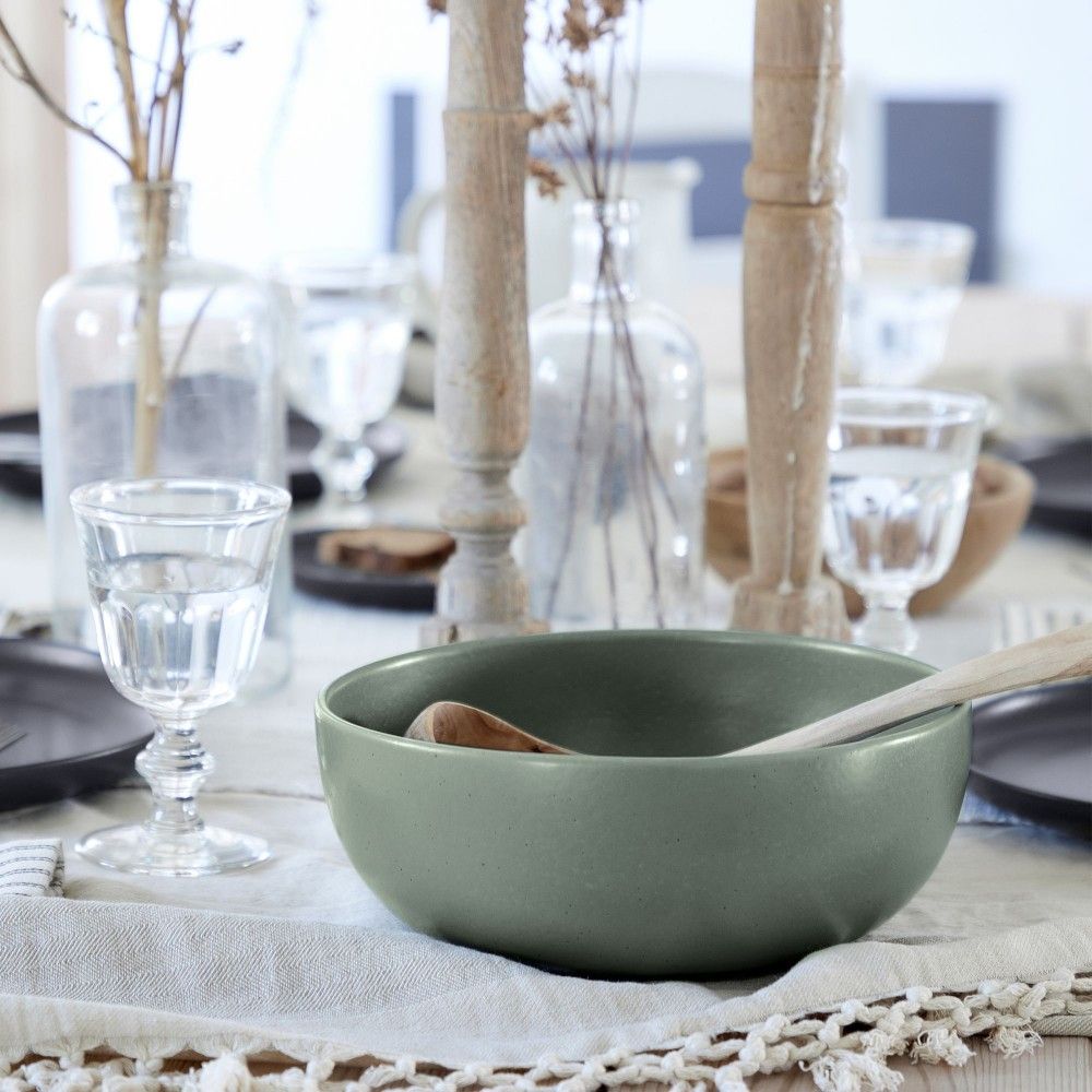 A matte finish green bowl from the Pacifica Artichoke Serveware collection by Casafina Living on a table.