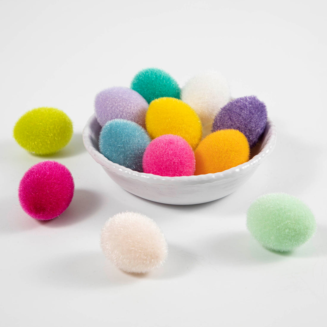 Flocked Easter eggs with tray in assorted colors by Glitterville on a white surface.
