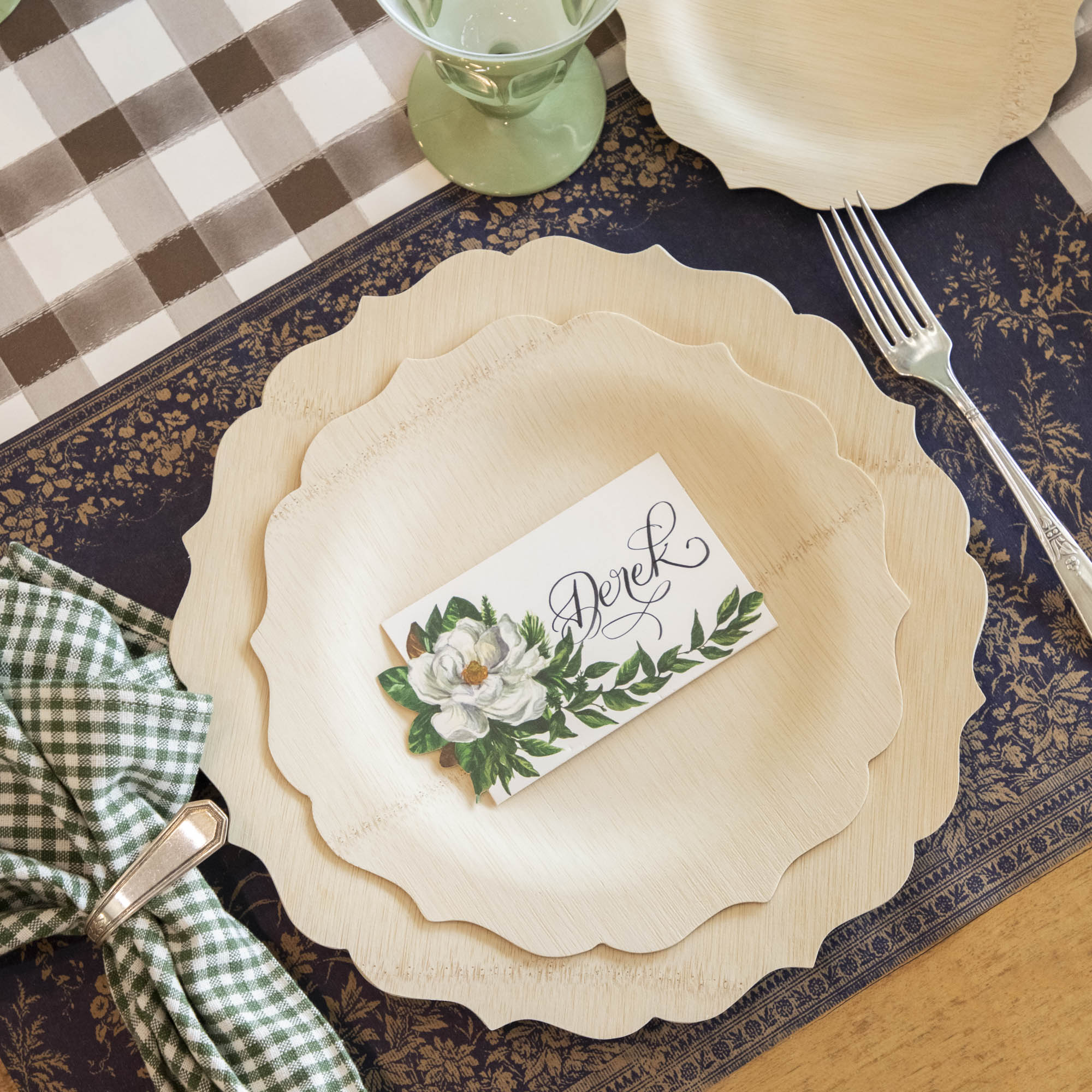 A compostable table setting with Veneerware Fancy Bamboo Plates certified by USDA organic, Bambu Wholesale napkins, and place cards.