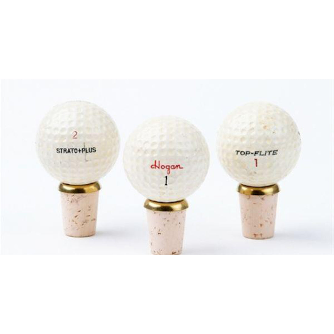 Three handcrafted Hester &amp; Cook Golf Ball Knobstoppers mounted on tees against a plain background.