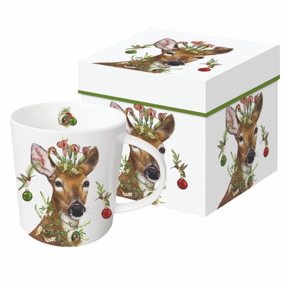 Mug with Vicki Sawyer artwork depicting a deer with hummingbirds around its head and various Christmas greenery.