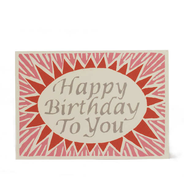 A pink and red birthday card with a sunburst design and the text &