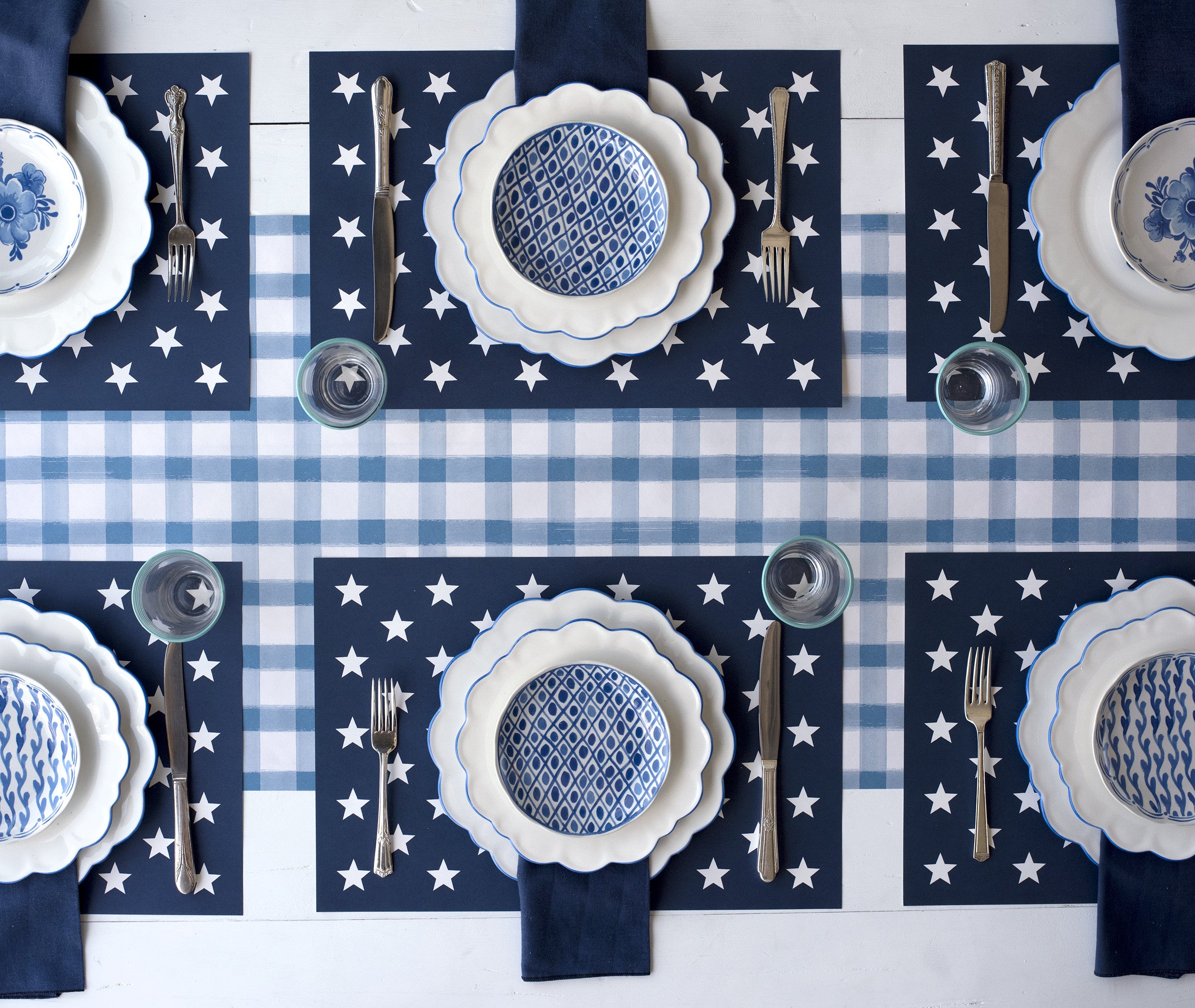 The Stars on Blue Placemat under an elegant table setting for six, from above.