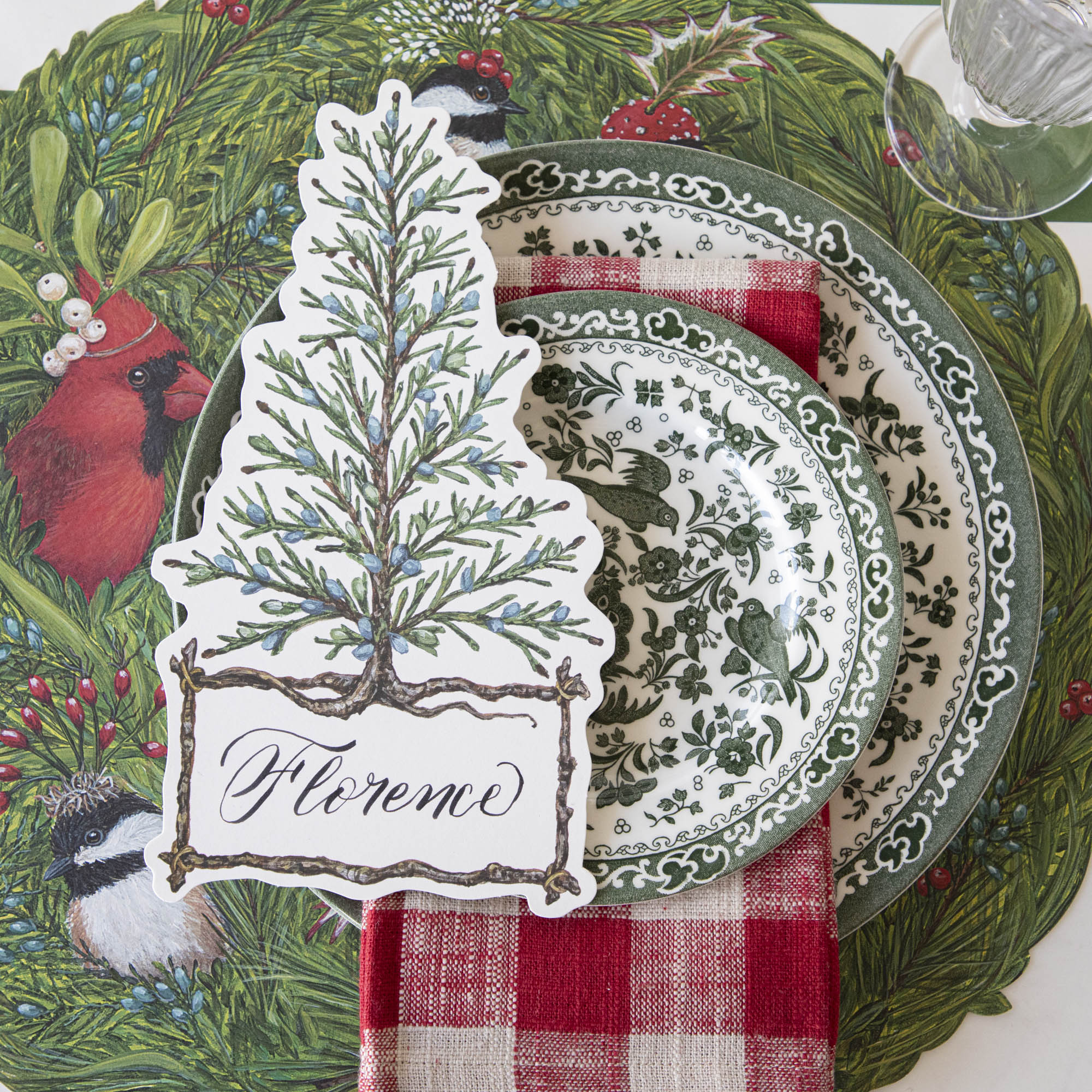 A table setting with a green and white place setting that features Burleigh&