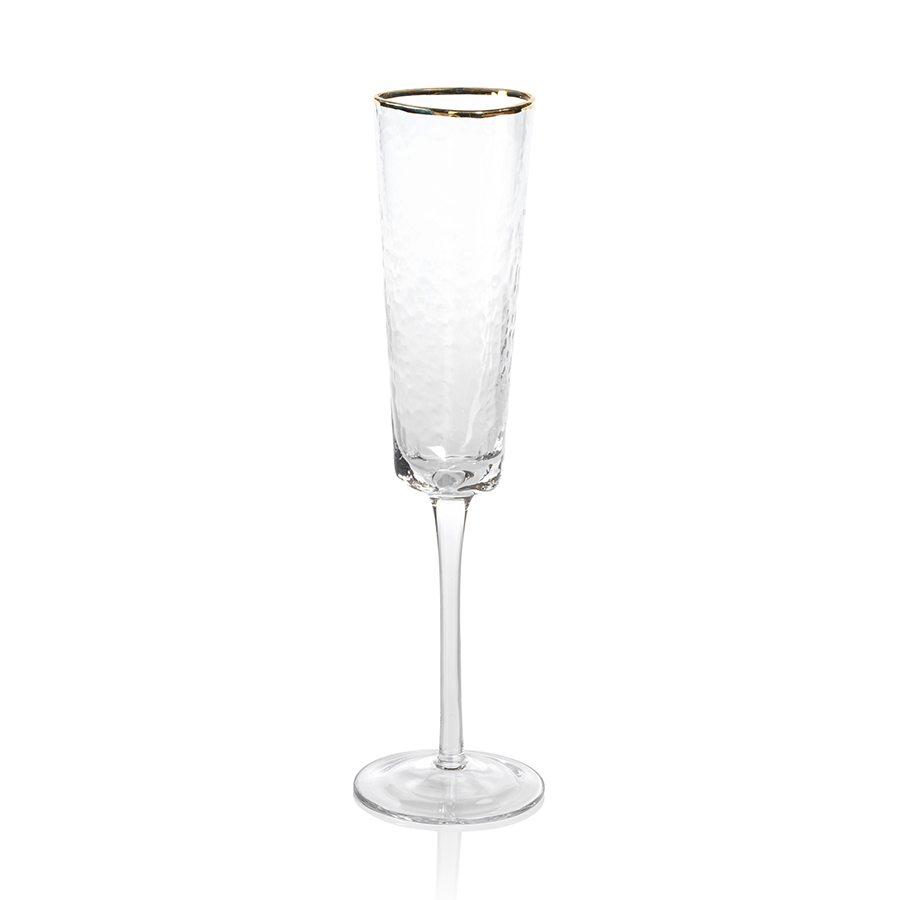 Two Zodax Hammered Glasses with Gold Rim on a tray with a bottle of champagne in the background.