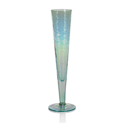 Four Zodax Luster Slim Champagne Flute Glassware with a champagne bottle in an ice bucket in the background.