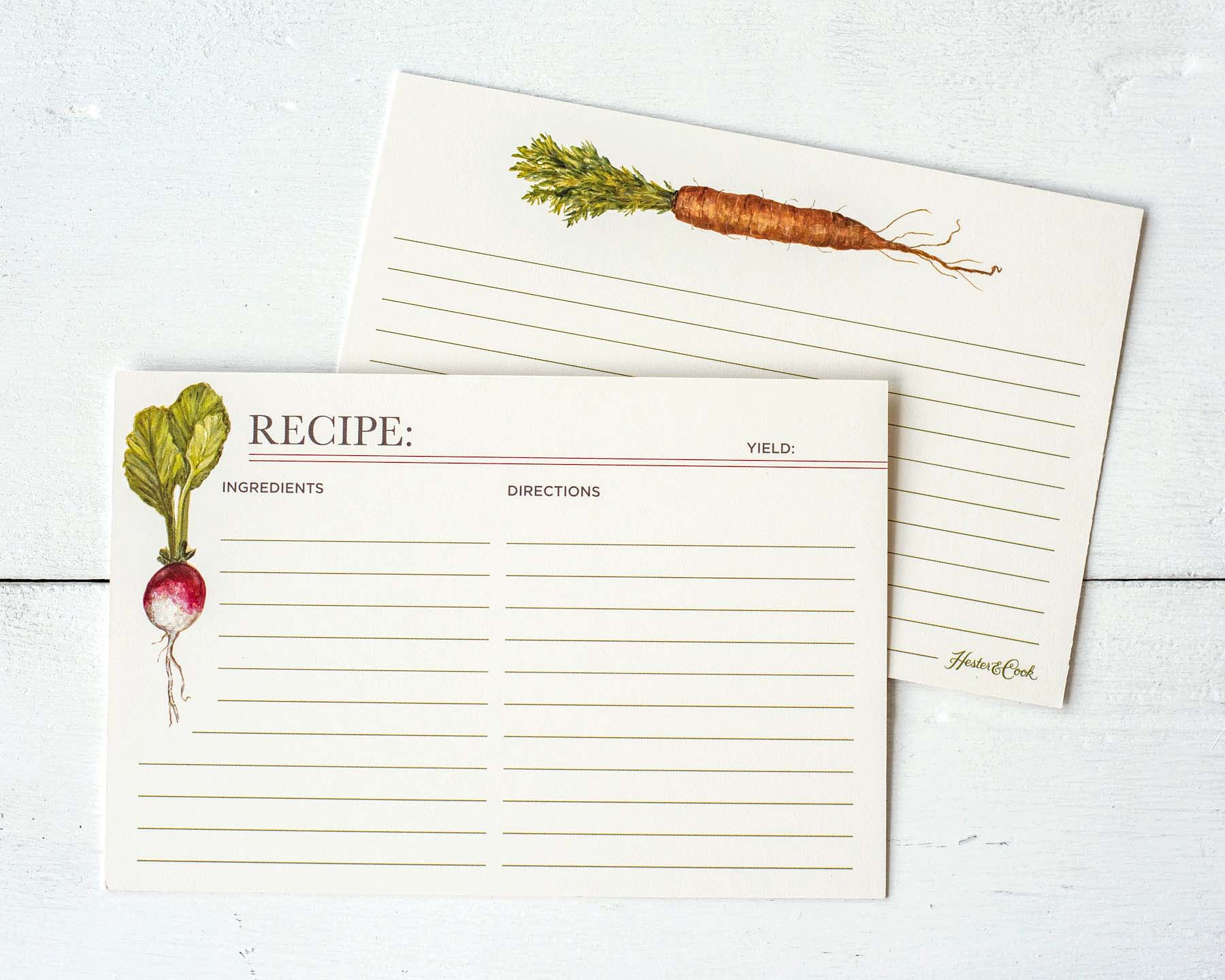 Both sides of a lined recipe card with space for ingredients and directions on the front, with more lined space on the back. The front of the card is adorned with a white and purple turnip with green leaves on the left side, and the back is adorned with an orange carrot with green leaves across the top.