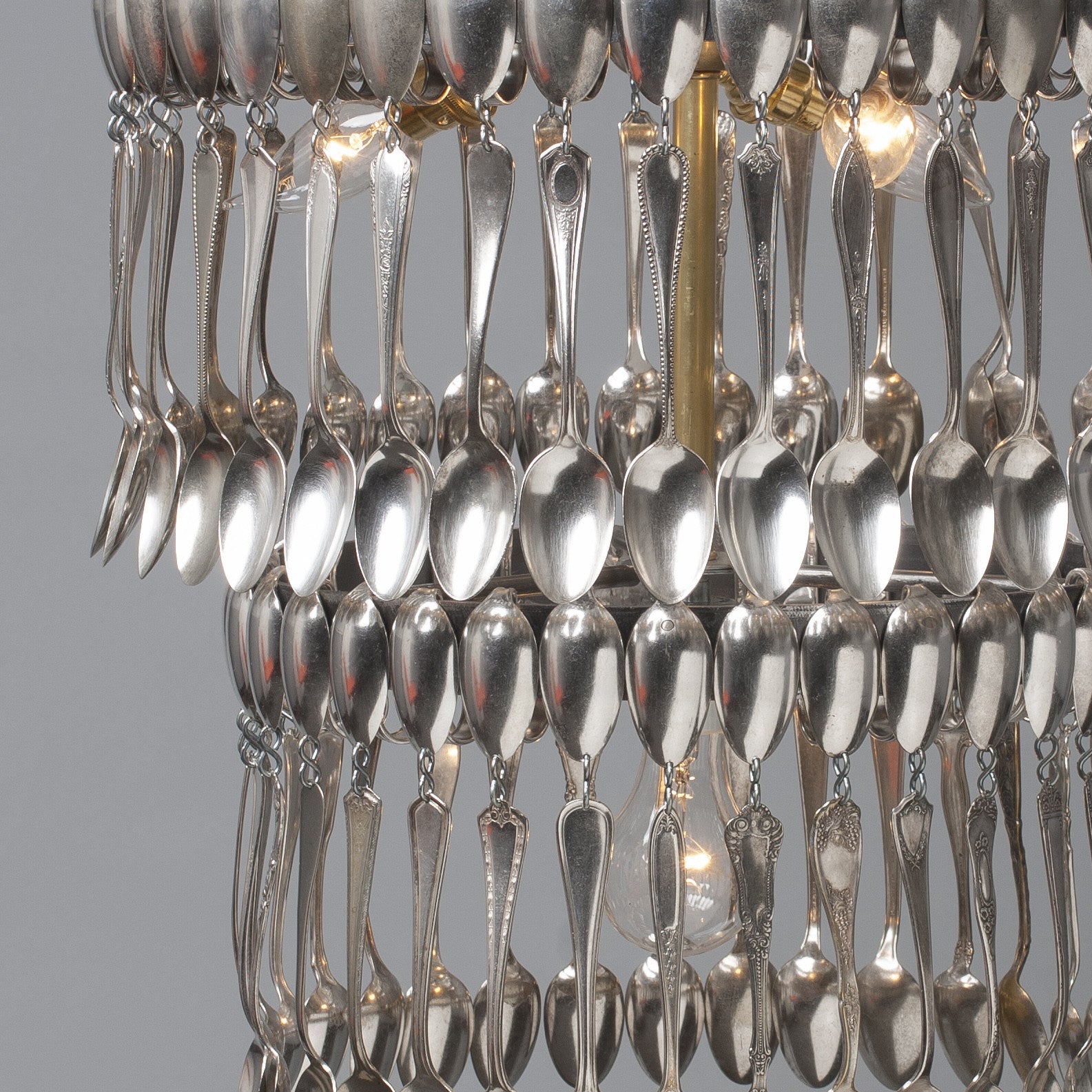 Double Tier Spoondelier made from repurposed vintage spoons and forks, hanging against a neutral background by Hester & Cook.