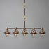 A Telegraph Pendant Lighting with four glass shades and antique insulators hanging from a brass frame. (Brand Name: Hester & Cook)