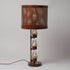 A traditional Hester & Cook Telegraph Table Top Lamp with a metal shade and a basket on top.