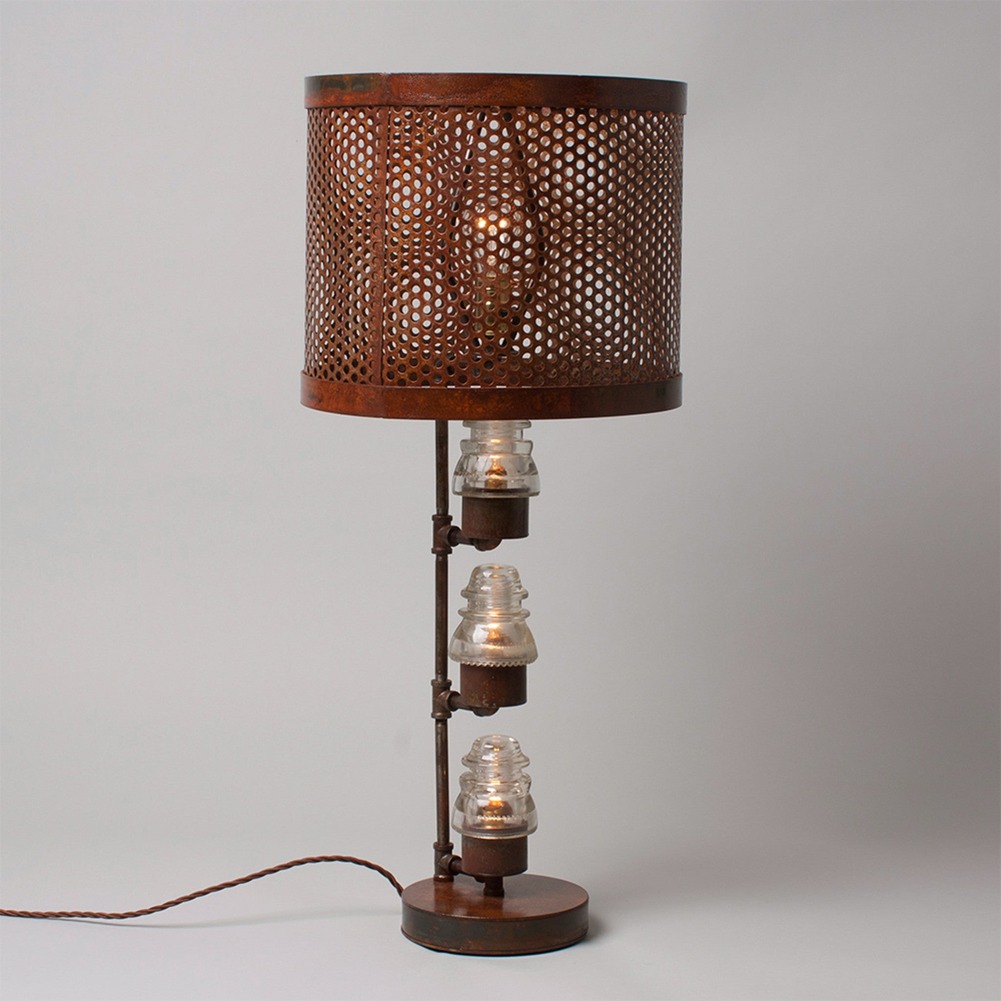 A traditional Hester & Cook Telegraph Table Top Lamp with a metal shade and a basket on top.