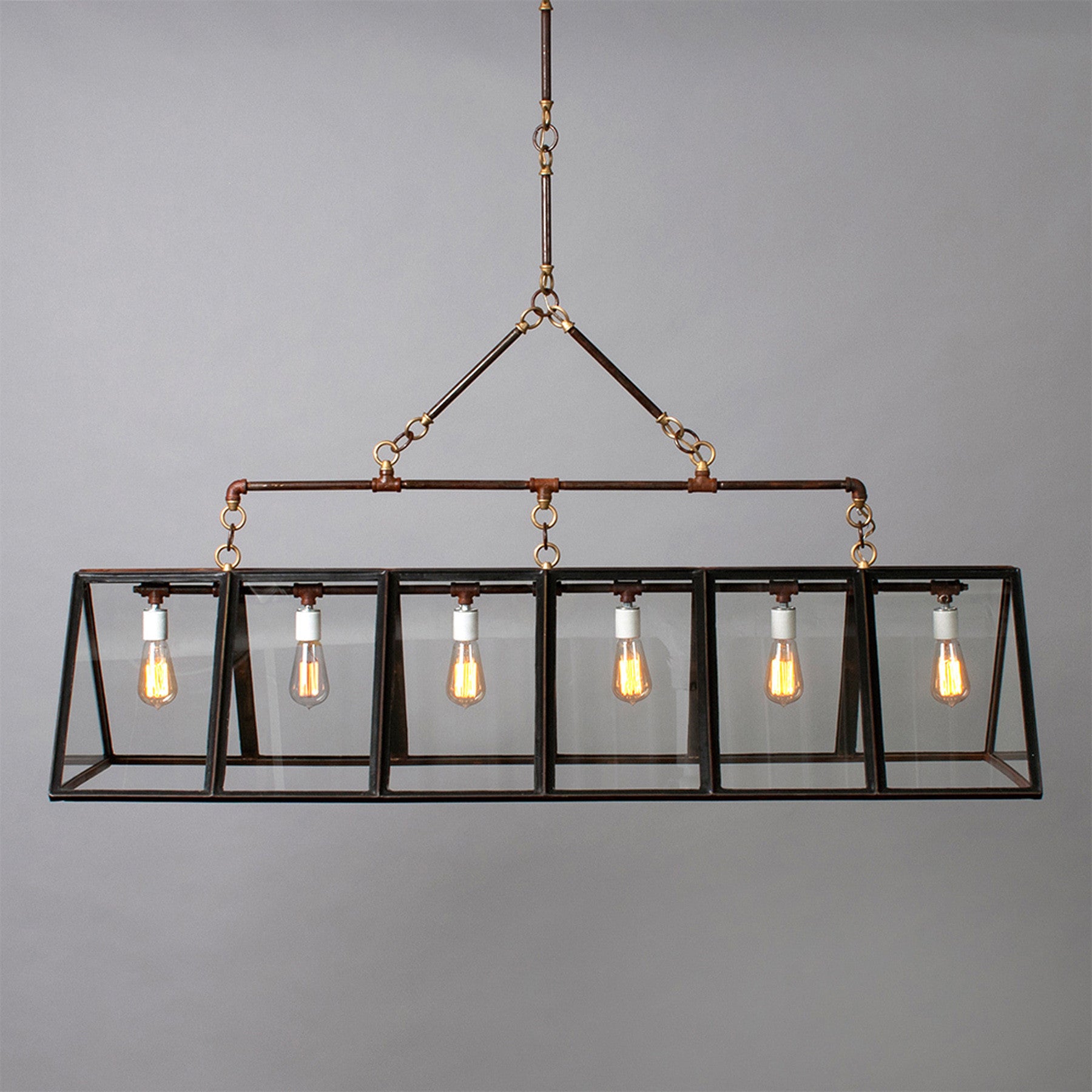 An industrial-style chandelier with five exposed vintage Edison bulbs by Hester &amp; Cook&