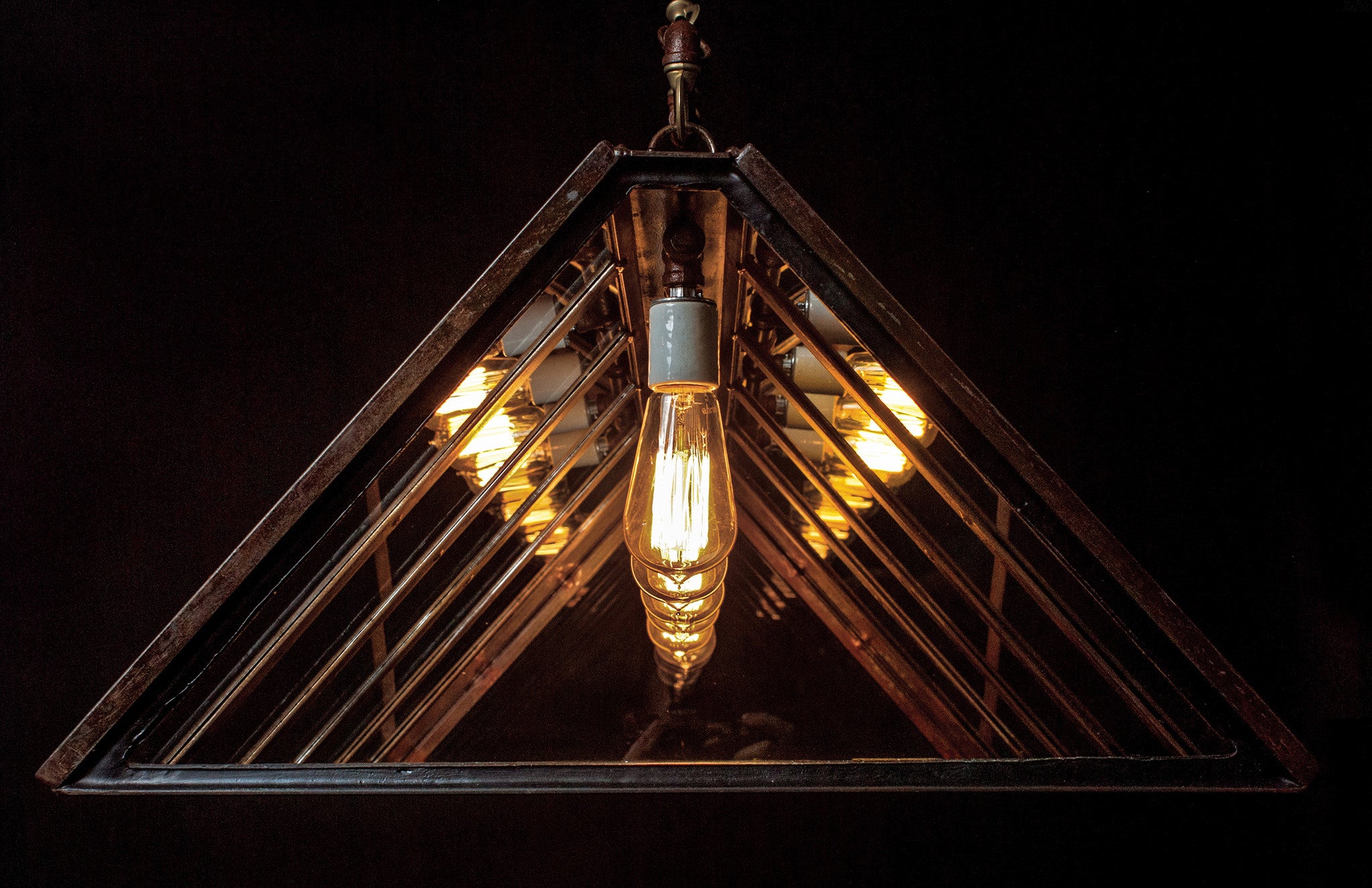 An industrial-style chandelier with five exposed vintage Edison bulbs by Hester &amp; Cook&