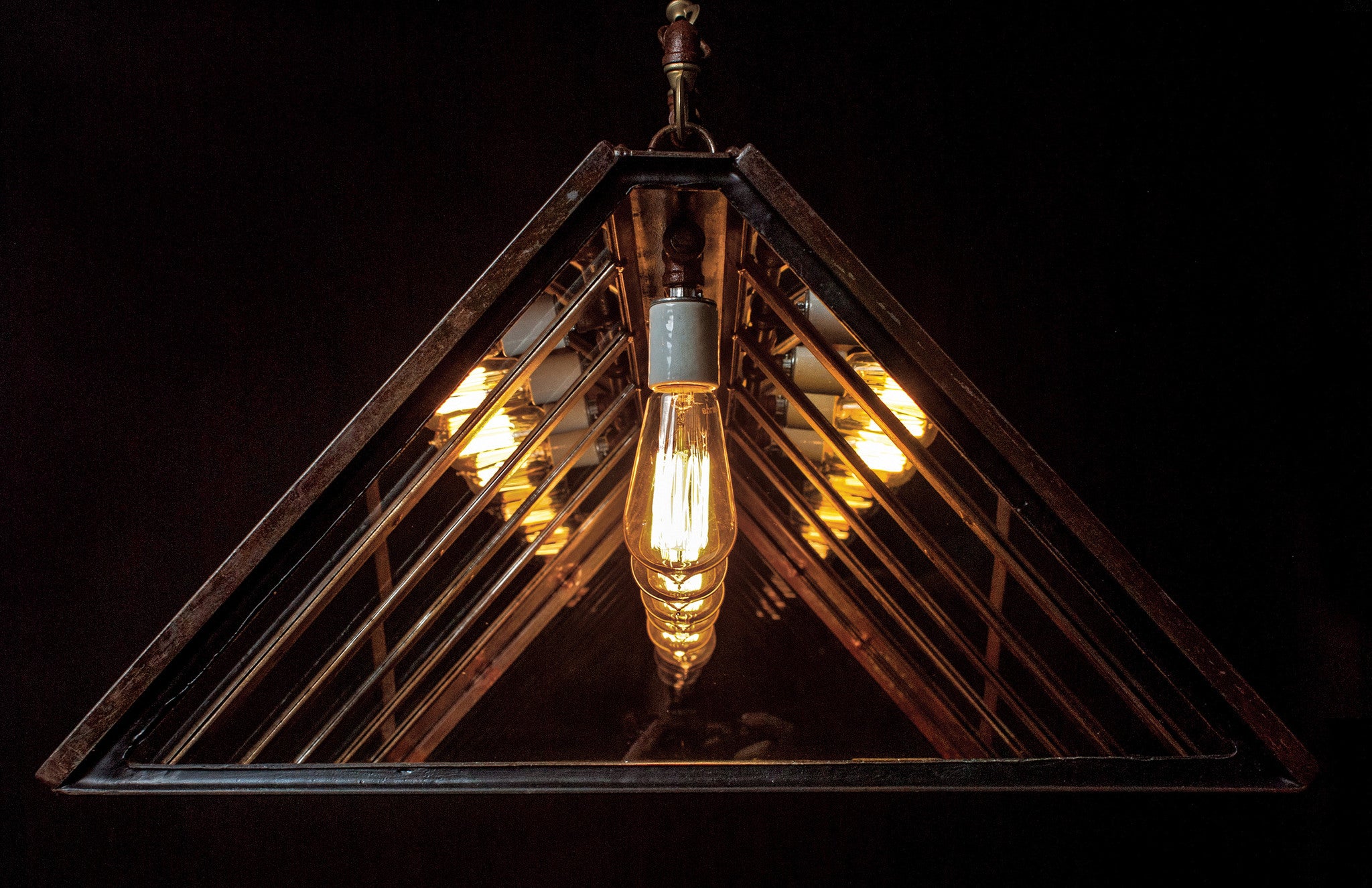 An industrial-style chandelier with five exposed vintage Edison bulbs by Hester & Cook&