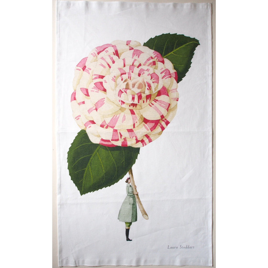 A In Bloom Camellia Linen Tea Towel by Hester &amp; Cook featuring botanical illustrations of a woman holding a pink flower.