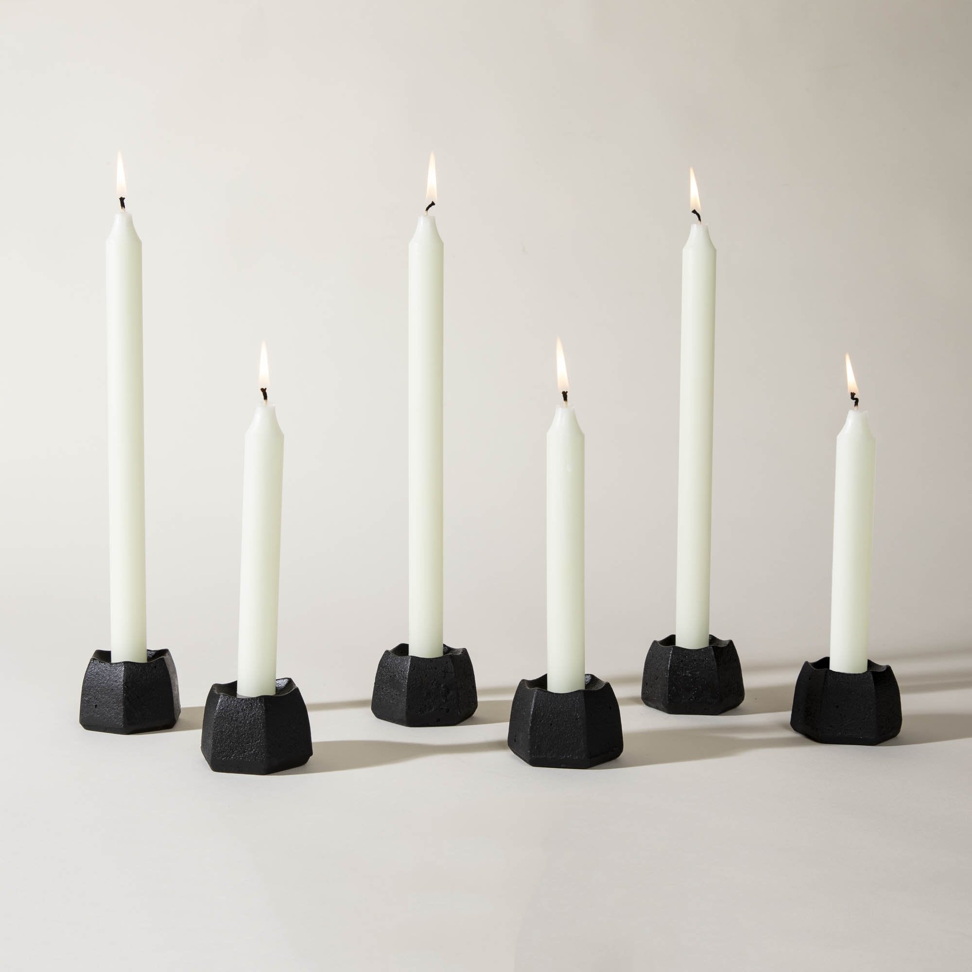 Several ivory taper candles by Northern Lights, lit.