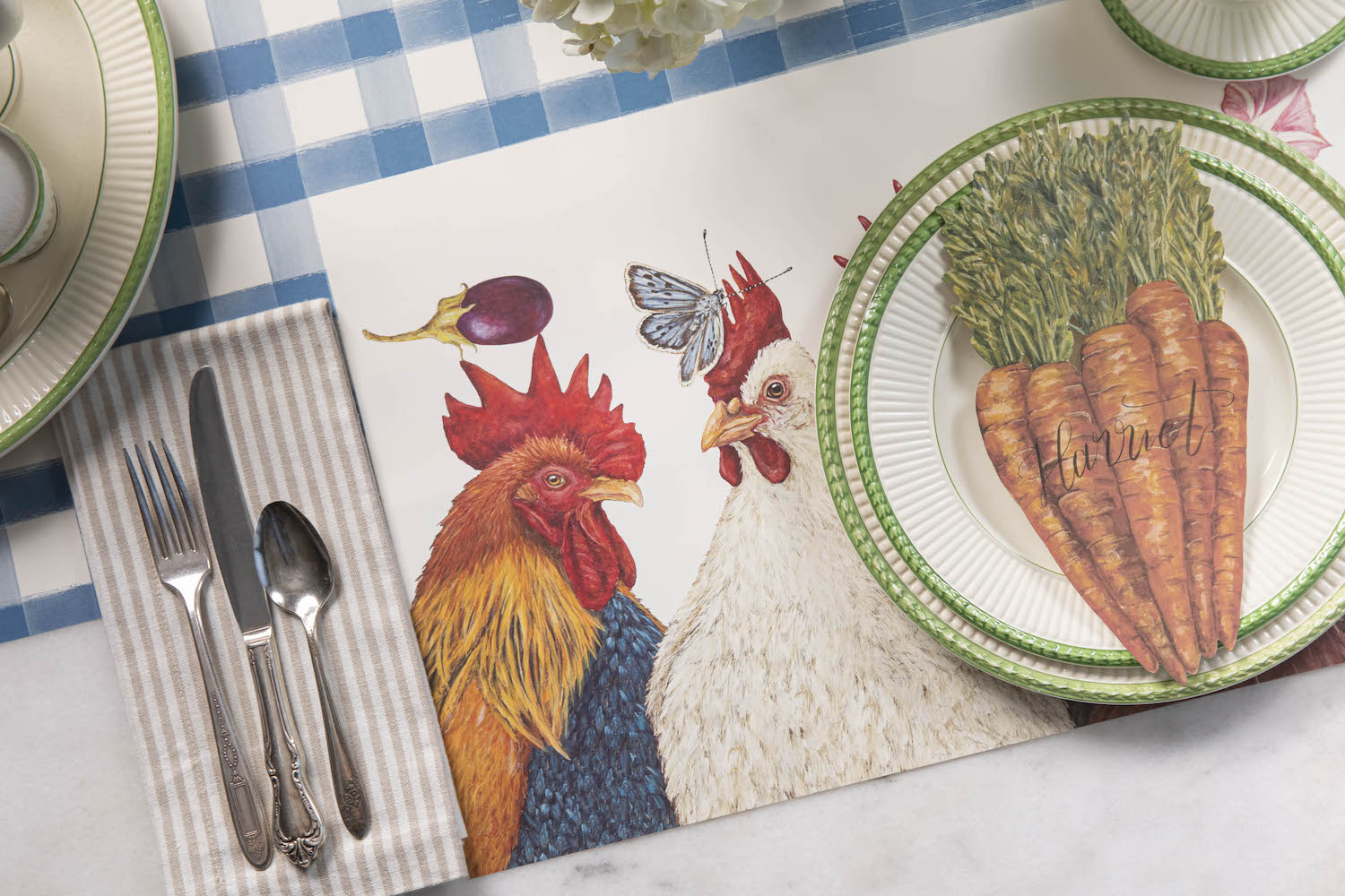 The Chicken Social Placemat under a charming place setting with the Carrot Table Accent.