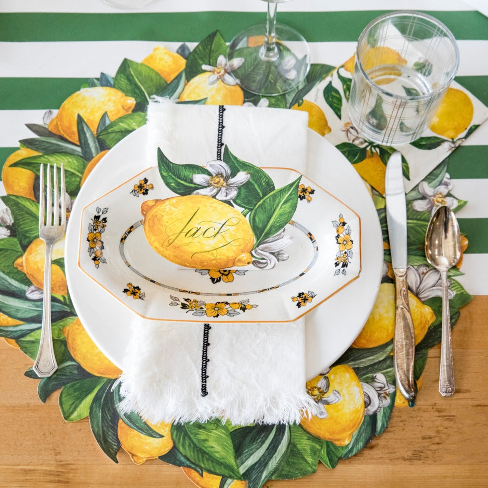 A spring-themed table setting with a Hester & Cook Lemon Place Card centerpiece.