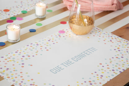 Table setting with Confetti Sprinkles Placemat with personalized message printed in sea foam color: &quot;Cue The Confetti!&quot;.