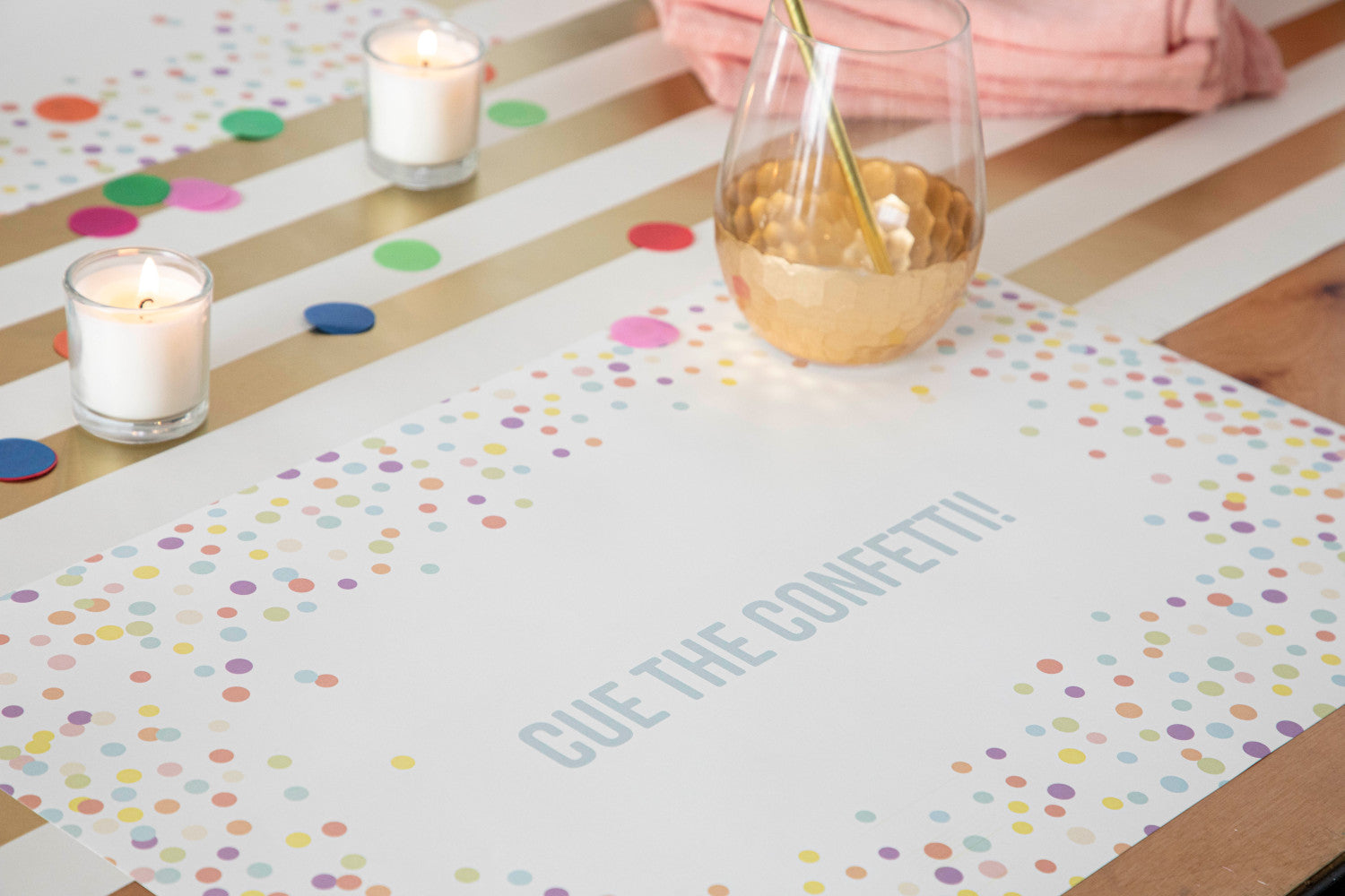Table setting with Confetti Sprinkles Placemat with personalized message printed in sea foam color: "Cue The Confetti!".