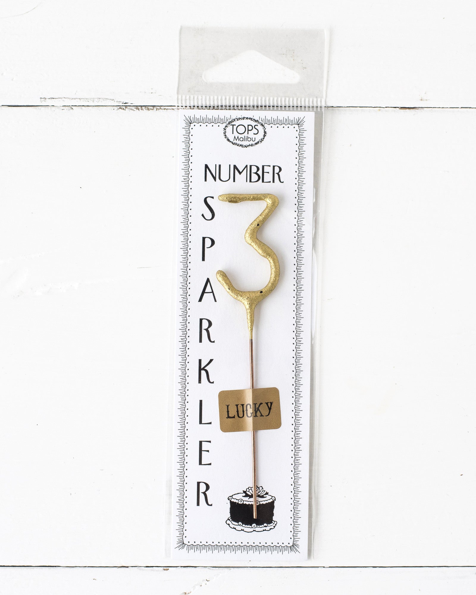 A Gold Number Cake Topper Sparkler, 4" tall, illuminating an instant party on a white background by Tops Malibu.