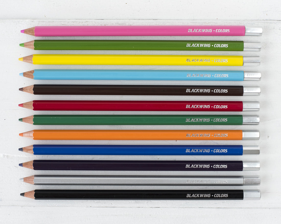 A set of 12 Blackwing Color Pencils with semi-hexagonal barrels, arrayed neatly in their packaging against a white background.