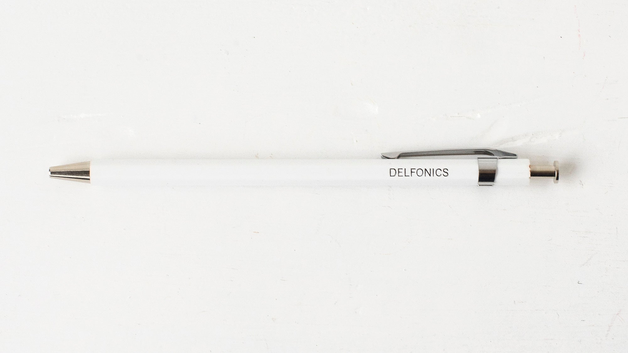 A white wooden ball pen with the brand name &