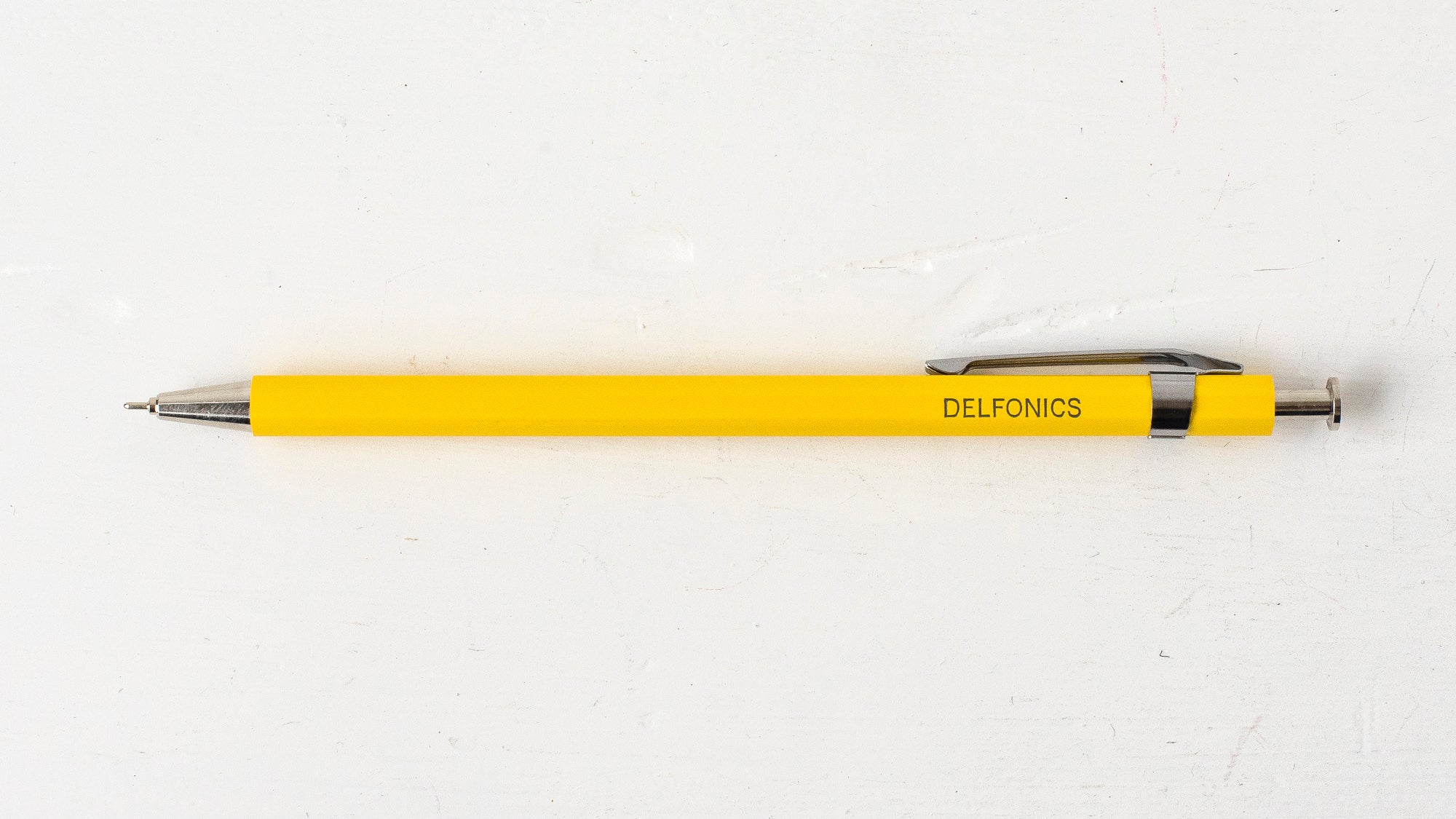 A yellow wooden ball pen with the brand name &