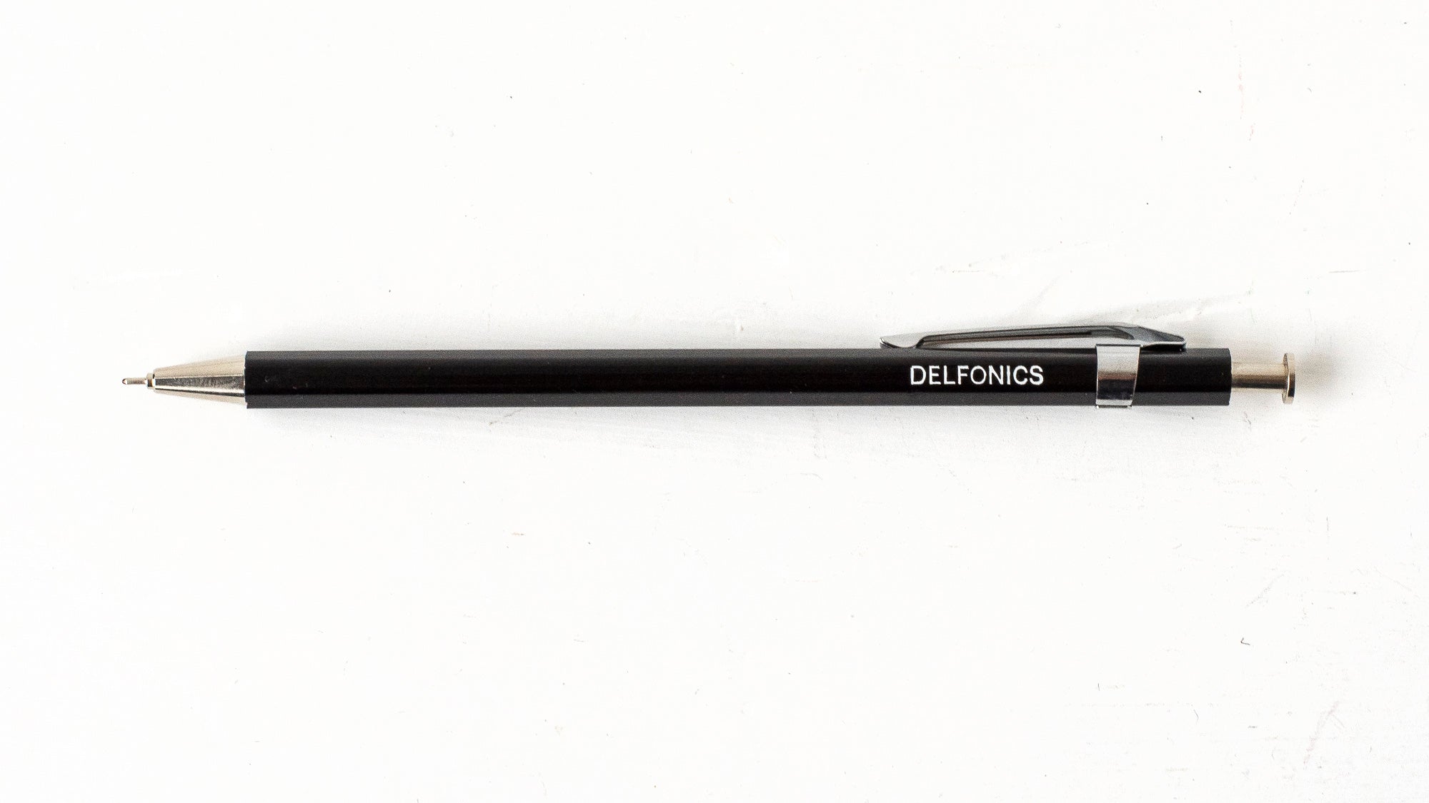 A black wooden ball pen with the brand name &