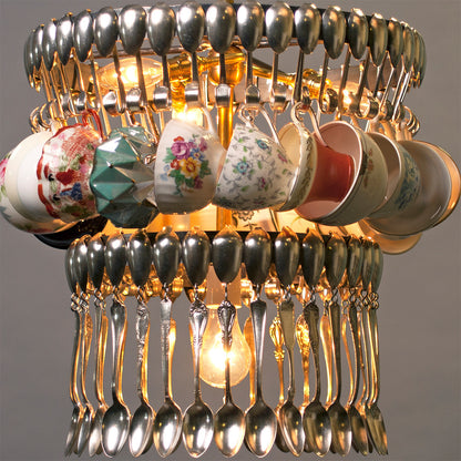 An unconventional Double Teacup chandelier made from suspended silverware and vintage teacups by Hester &amp; Cook.