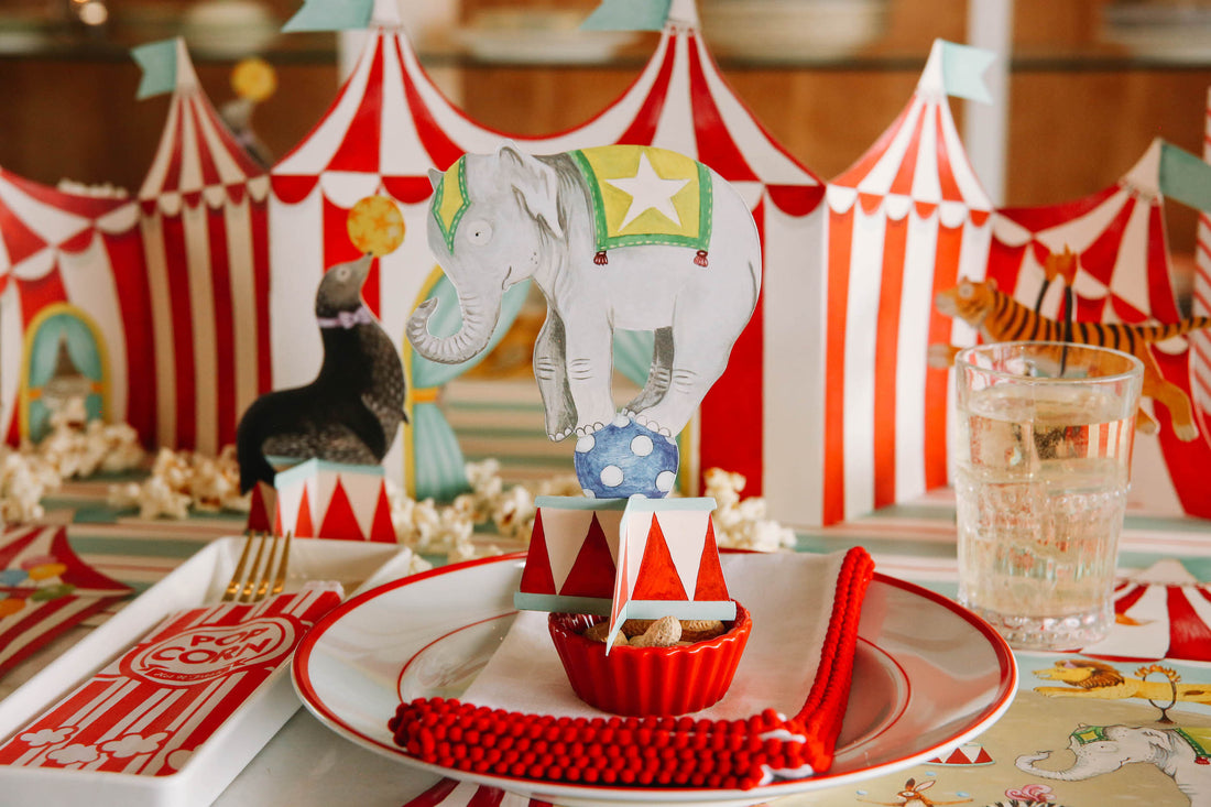 A vibrant circus-themed tablescape, featuring the Circus Trio Table Ornaments adding flair to the festivities.