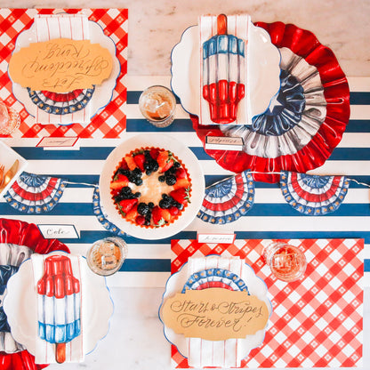 The red Picnic Check Placemat under a patriotic-themed table setting, from above.