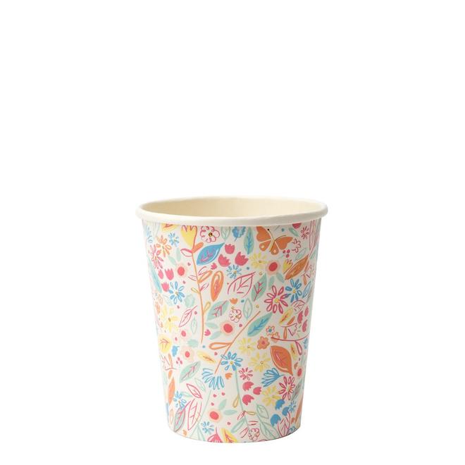 A paper cup with a colorful floral pattern and gold foil details.
