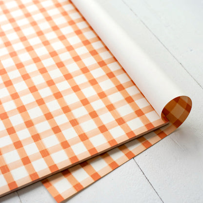 Close-up of the top right corner of the Orange Painted Check Placemat, showing the top sheet flipped back.