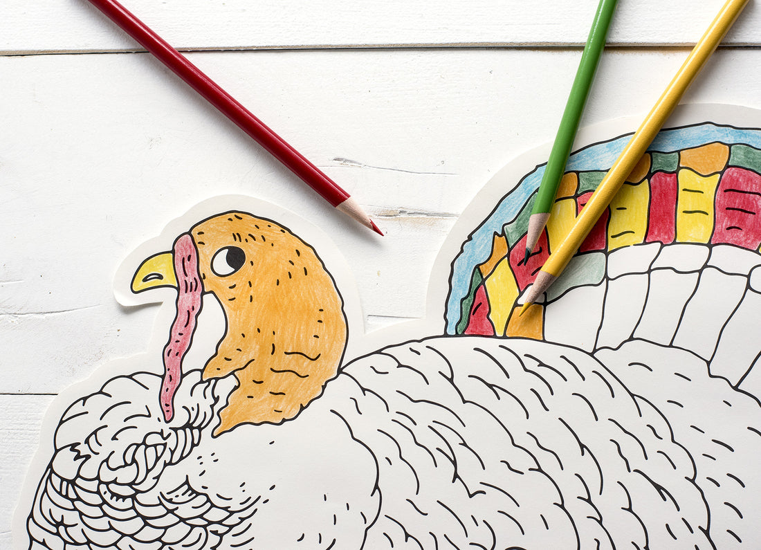 Close-up of the Die-cut Coloring Turkey Placemat, partially filled in with colored pencils. 