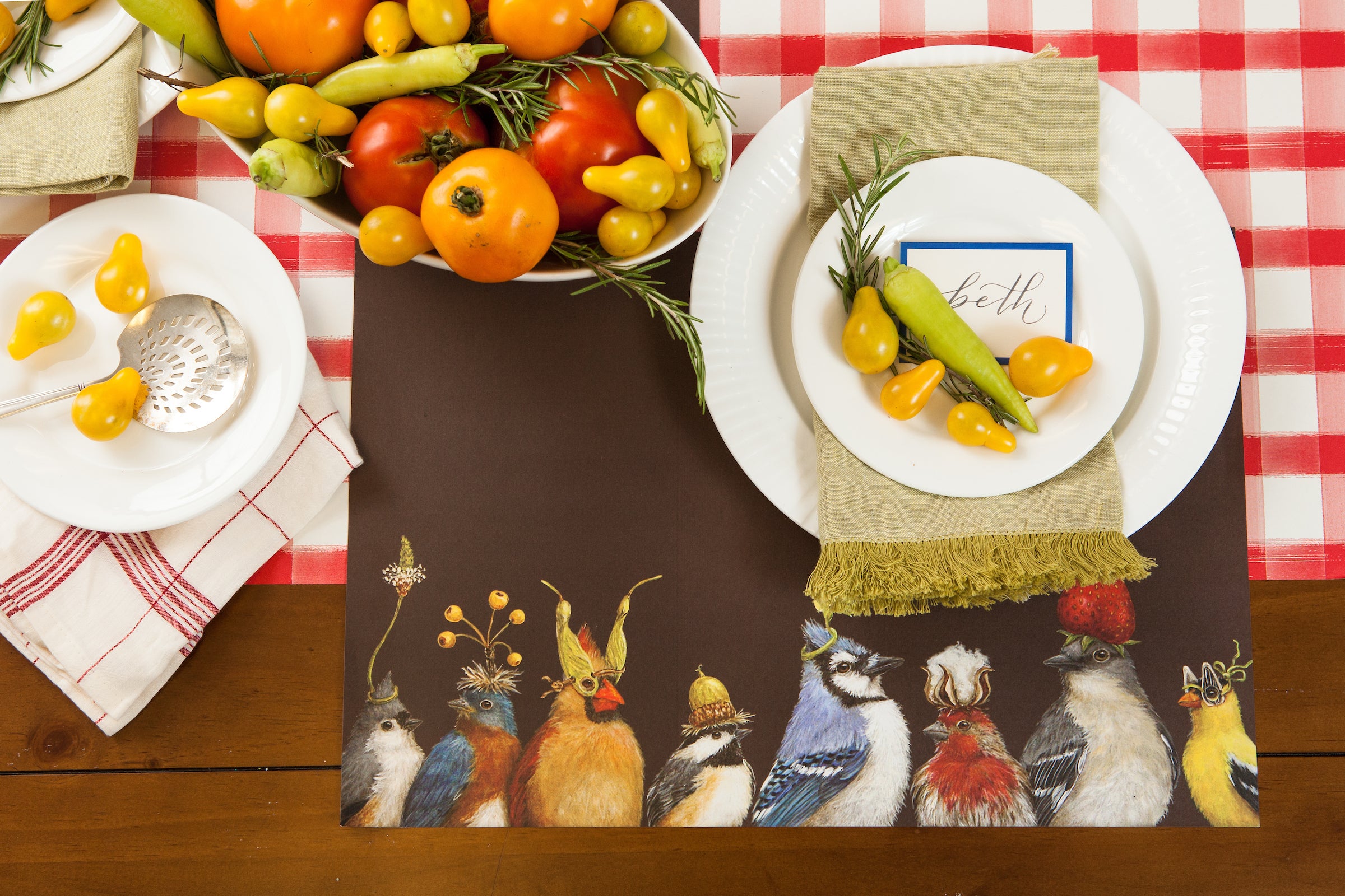 The Backyard Party Placemat used in a table setting with a bowl of vegetables.