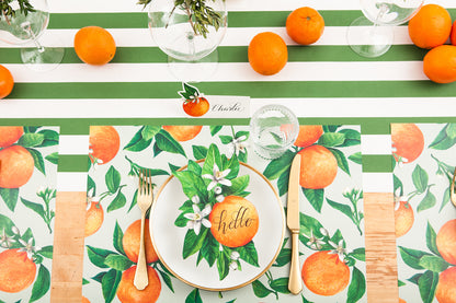 A citrus-themed table setting featuring Orange Blossom Table Accents resting on each plate.