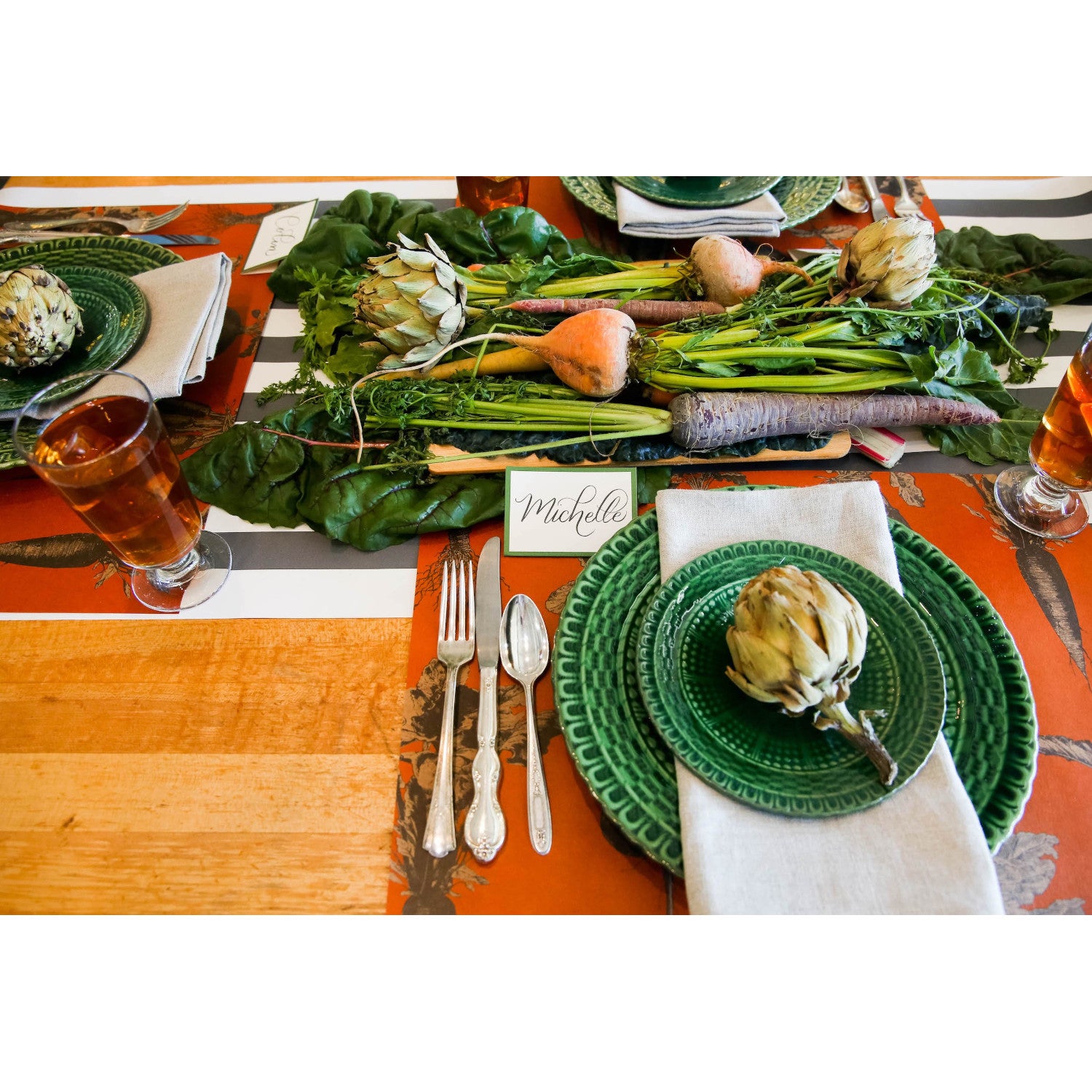 The Harvest Vegetable (Persimmon) Placemat under a rustic table setting.