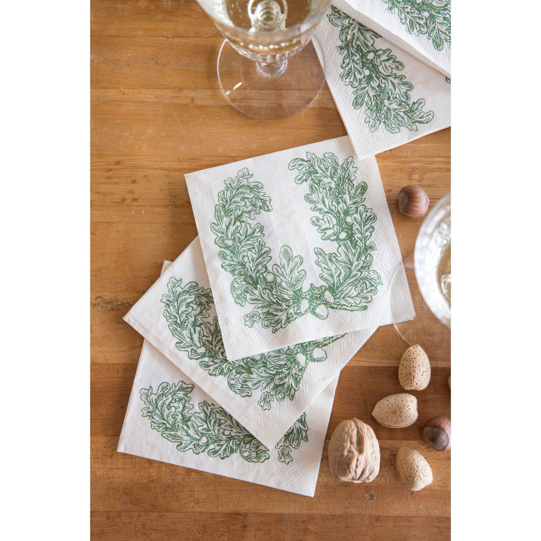 Several Oak Leaves Cocktail Napkins spread over a rustic table setting.