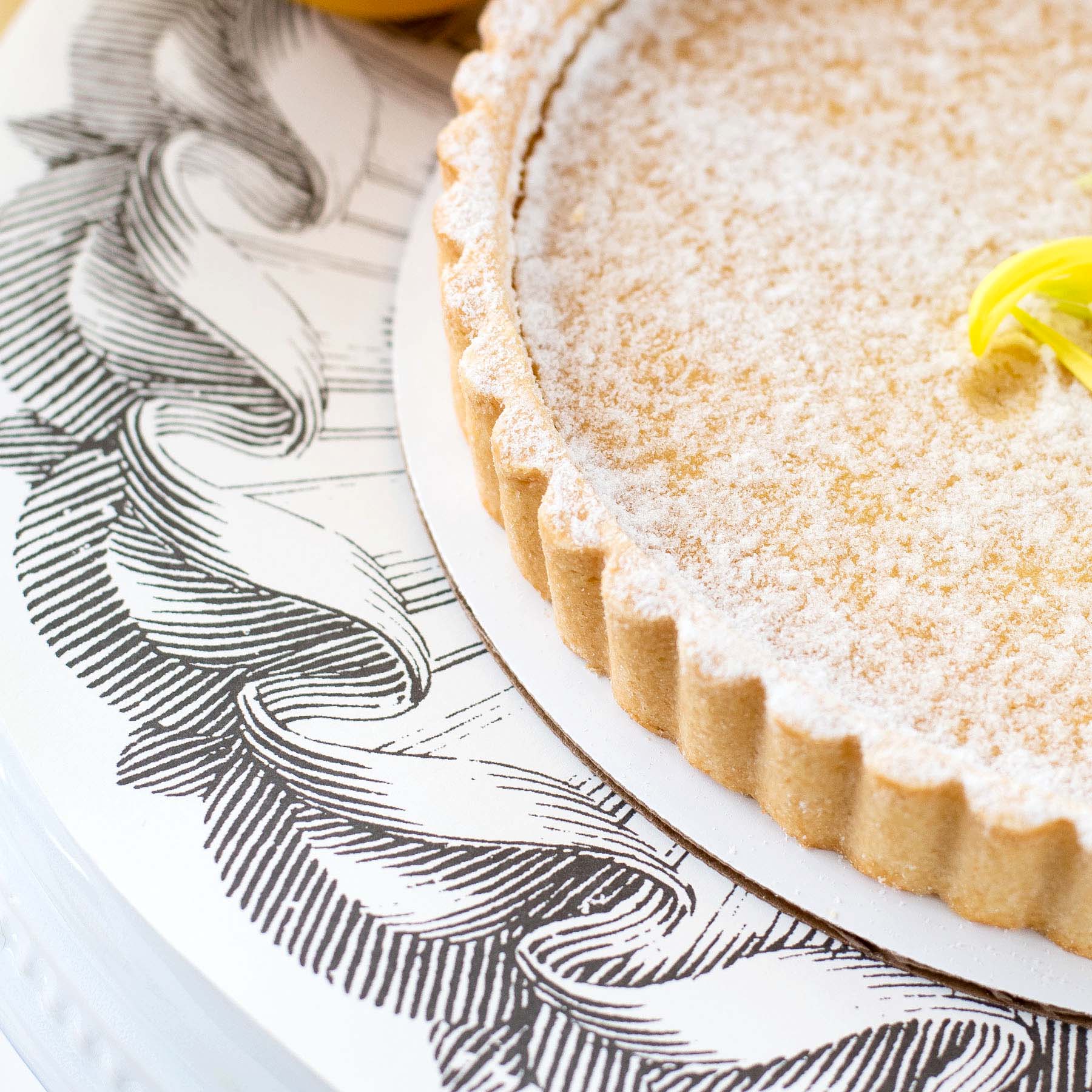 Close-up of a Rosette Serving Paper under a dessert, adding elegance to the tablescape.