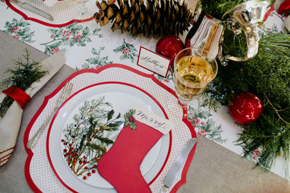 A Christmas tablescape adorned with red and white decorations, including Hester &amp; Cook&