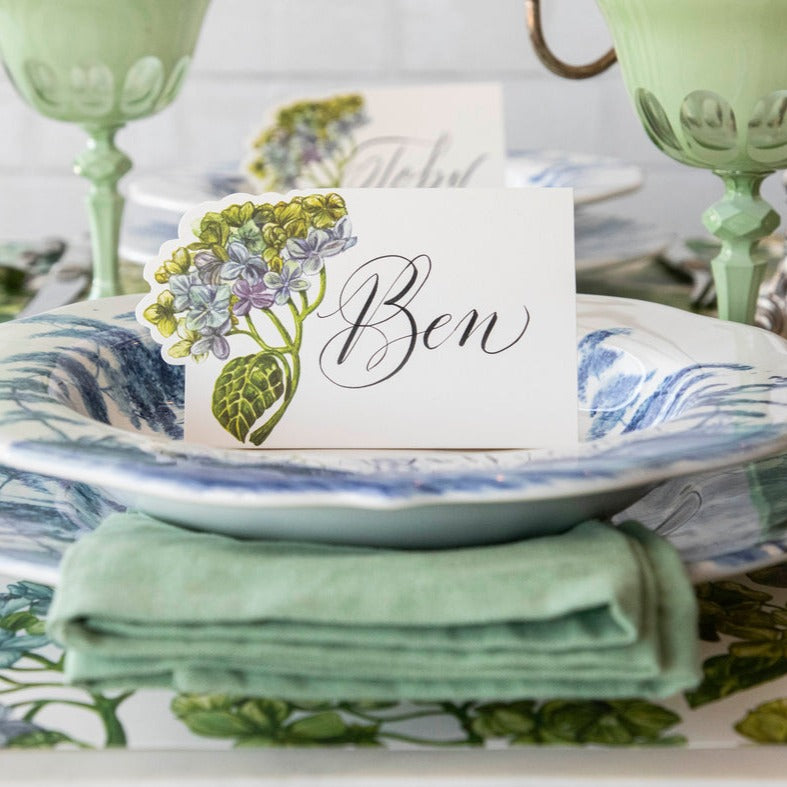 A Hester & Cook Hydrangea Place Card adorns a blue and white table setting.