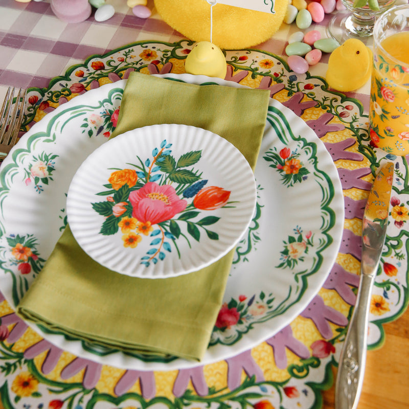 A white melamine plate with colorful flowers on it. 
Product Name: Floral &quot;Paper&quot; Salad Plate 
Brand Name: Glitterville