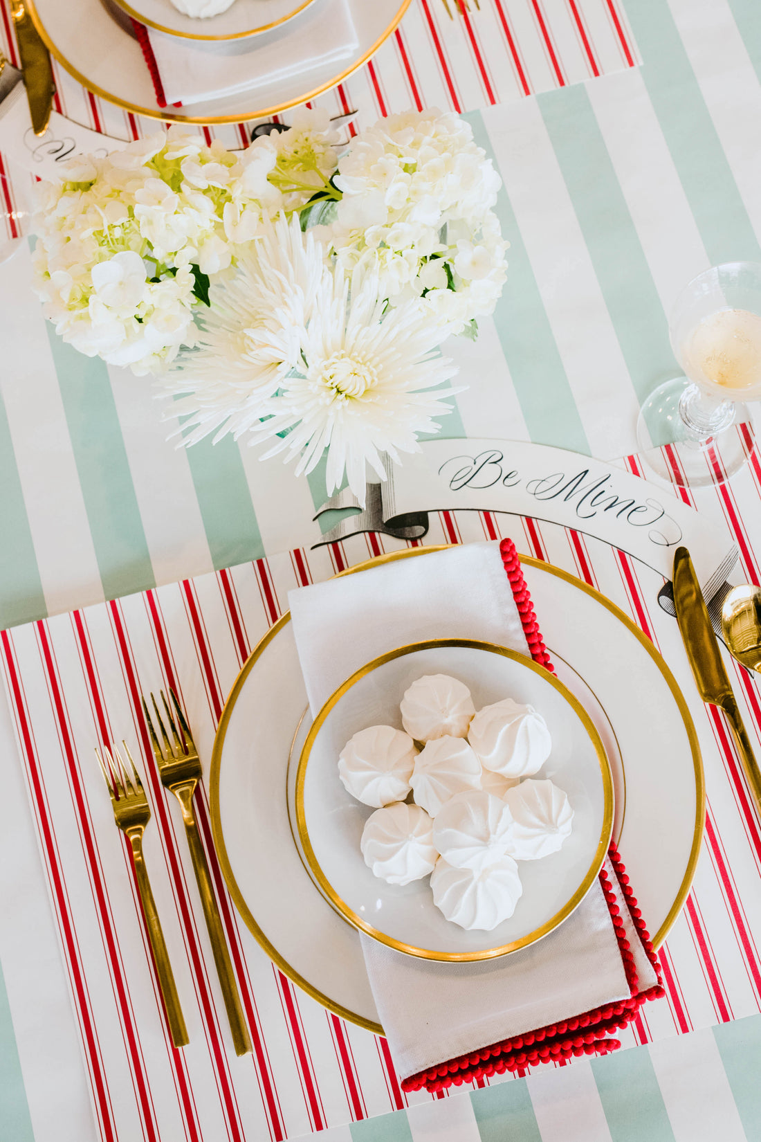 The Red Ribbon Stripe Placemat under an elegant springtime table setting, from above.